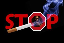 Stop sign, lit cigarette and skull